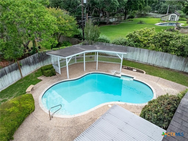 view of pool with a fenced in pool, a fenced backyard, and a yard