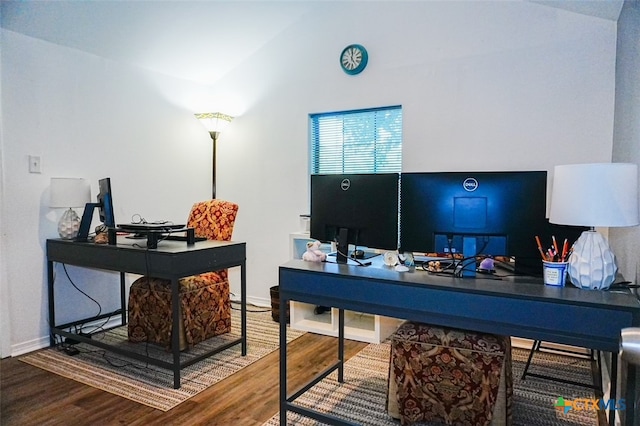 home office with hardwood / wood-style flooring and vaulted ceiling