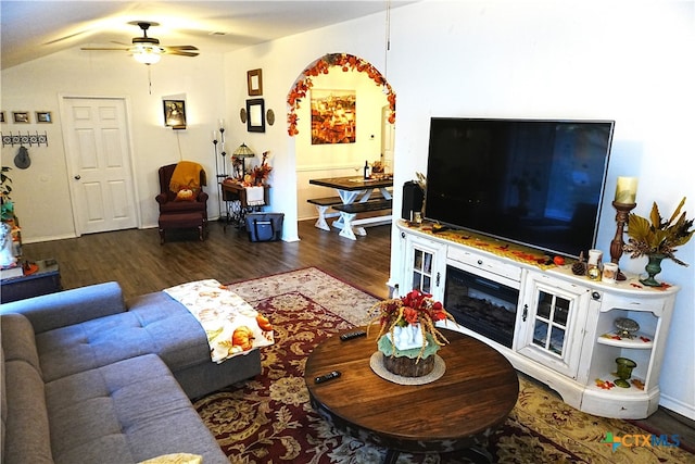 living room with ceiling fan and dark hardwood / wood-style floors