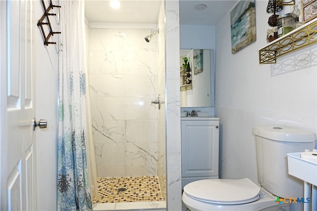 bathroom featuring curtained shower, toilet, and sink