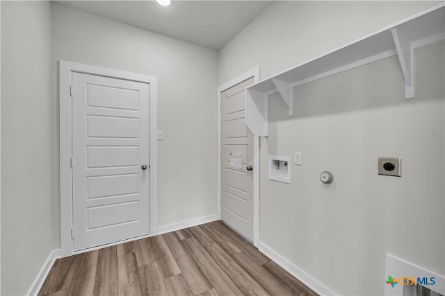 laundry room featuring gas dryer hookup, washer hookup, hookup for an electric dryer, and light hardwood / wood-style flooring