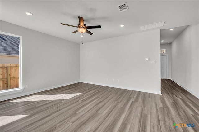 empty room with ceiling fan and light wood-type flooring