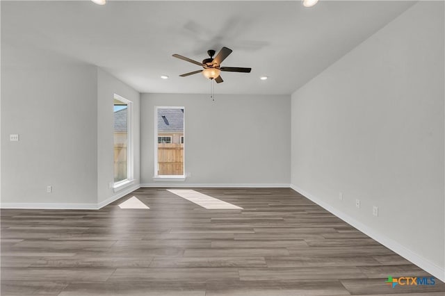 spare room featuring hardwood / wood-style flooring and ceiling fan