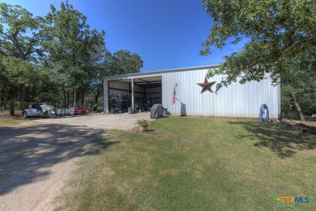 view of outbuilding with a yard