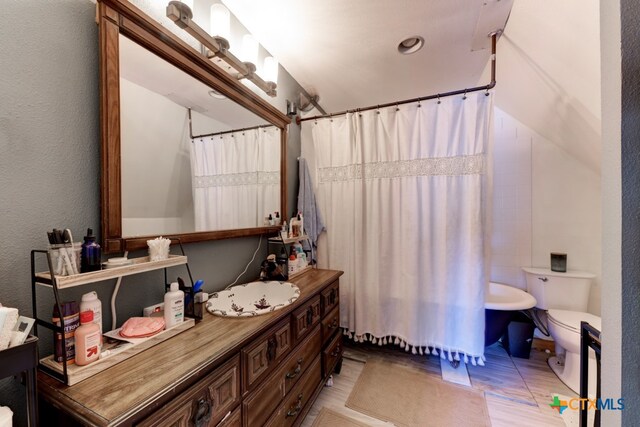 bathroom with tile patterned floors, vanity, and toilet