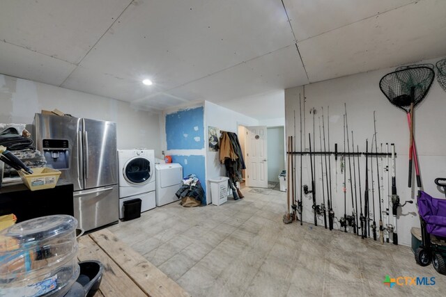 interior space featuring stainless steel refrigerator with ice dispenser and independent washer and dryer