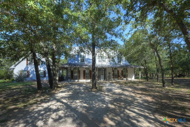 farmhouse inspired home with a porch