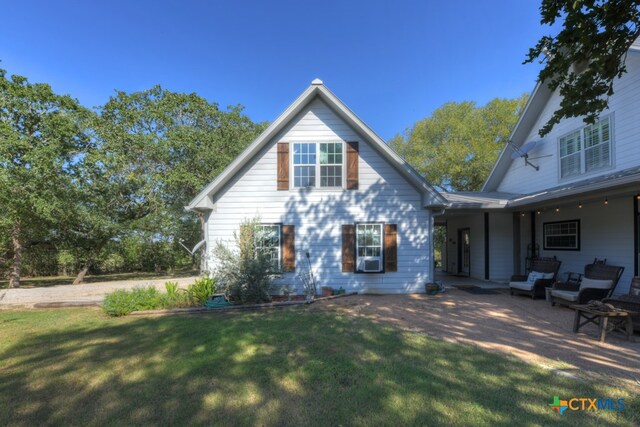 view of front facade with a front yard and a patio area