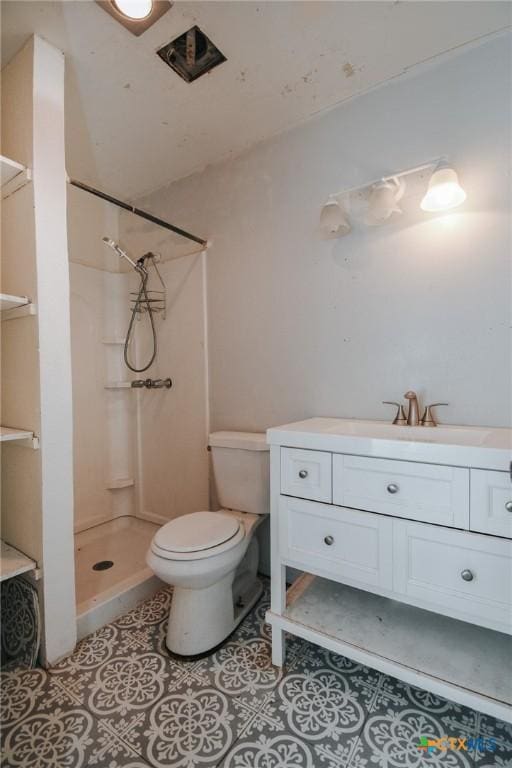 full bathroom with toilet, a shower stall, vanity, and tile patterned floors