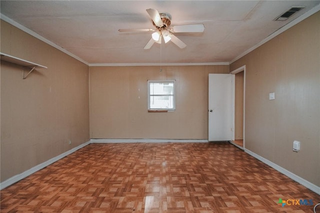 spare room featuring ceiling fan, ornamental molding, visible vents, and baseboards