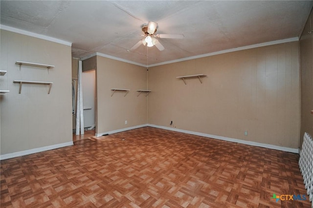 empty room featuring ornamental molding, baseboards, and a ceiling fan