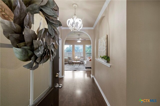5928 Alexandria Dr, Temple, TX 76502 - hallway featuring arched walkways, a chandelier, ornamental molding, and dark wood-type flooring