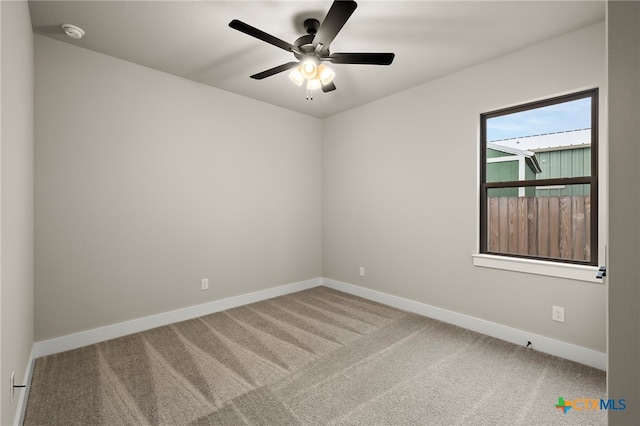 unfurnished room featuring ceiling fan and carpet floors