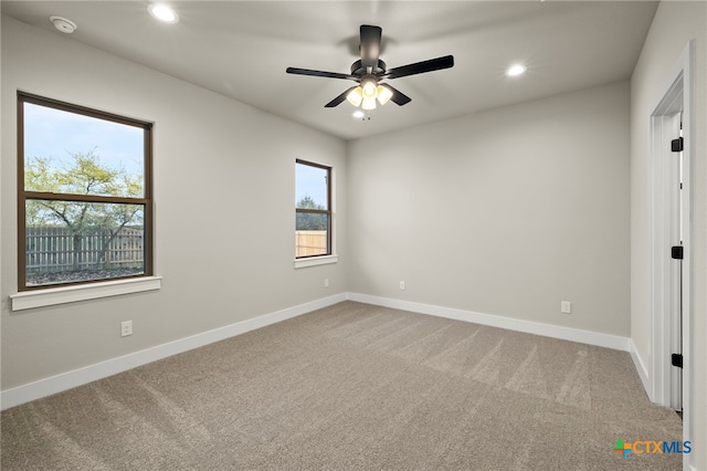 spare room with carpet flooring and ceiling fan