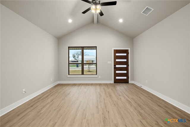 empty room featuring ceiling fan, light hardwood / wood-style floors, and high vaulted ceiling