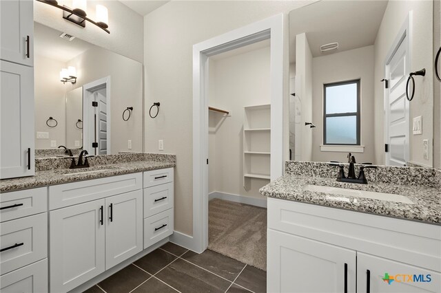 bathroom featuring tile patterned flooring and vanity