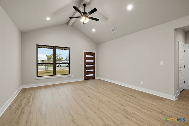 empty room featuring vaulted ceiling with beams, ceiling fan, and light hardwood / wood-style flooring