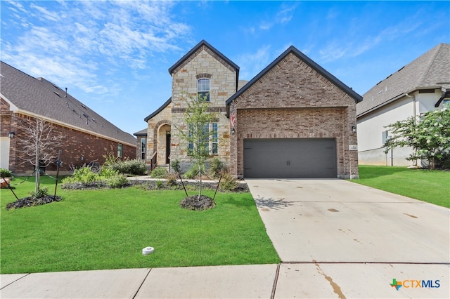 view of front of property with a garage and a front lawn