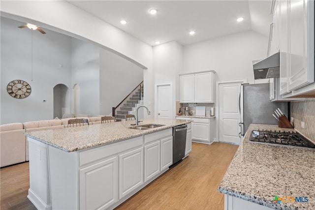 kitchen featuring white cabinetry, sink, a kitchen island with sink, and high vaulted ceiling