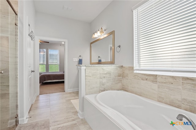 bathroom featuring a tub, tile patterned floors, and ceiling fan