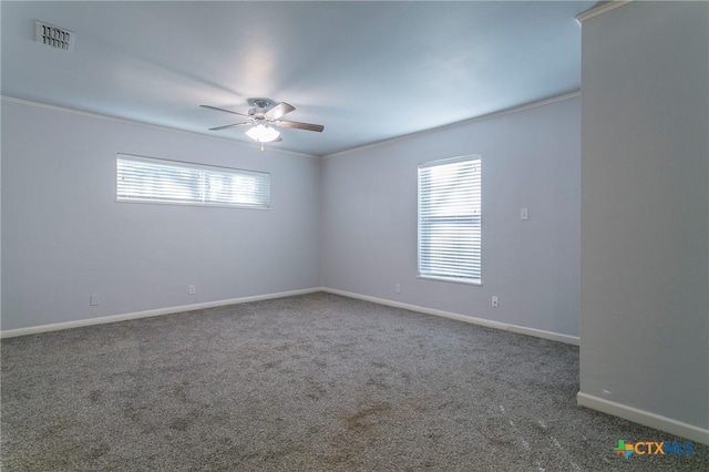 carpeted empty room with ceiling fan and ornamental molding