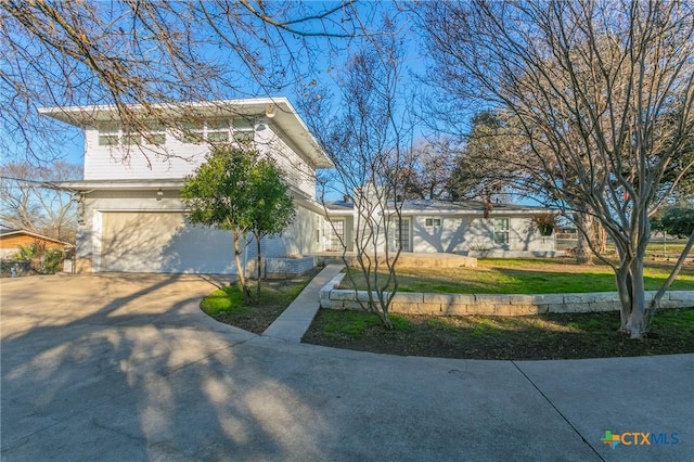 view of front of house featuring a garage and a front lawn