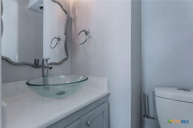 bathroom with vanity and toilet