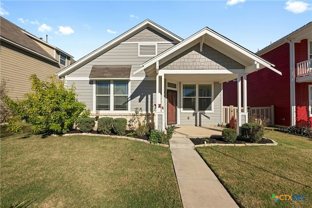 view of front of property featuring covered porch and a front yard