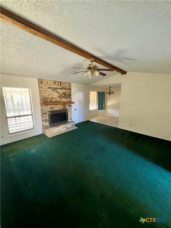 unfurnished living room with a fireplace, carpet, lofted ceiling with beams, and a textured ceiling