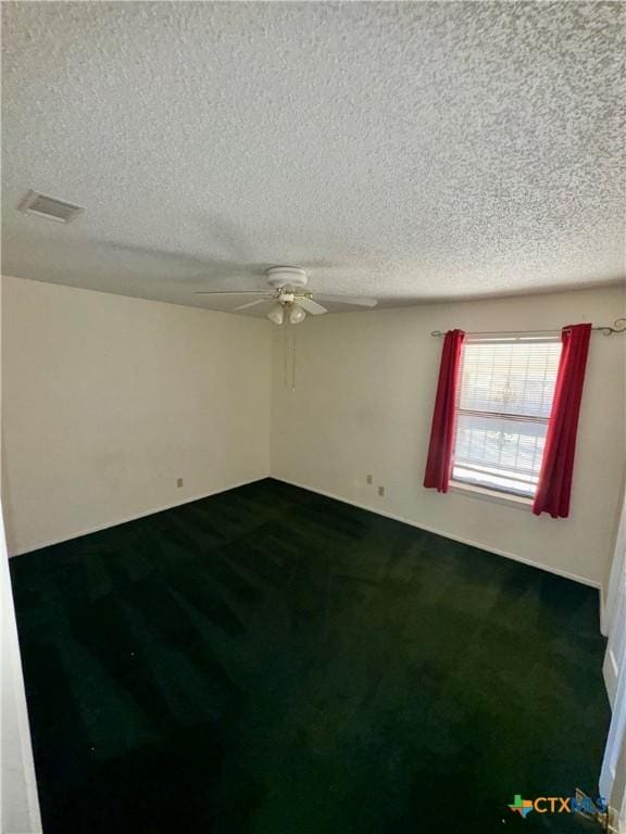 unfurnished room featuring carpet flooring, ceiling fan, and a textured ceiling