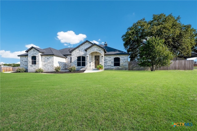 french provincial home with a front lawn