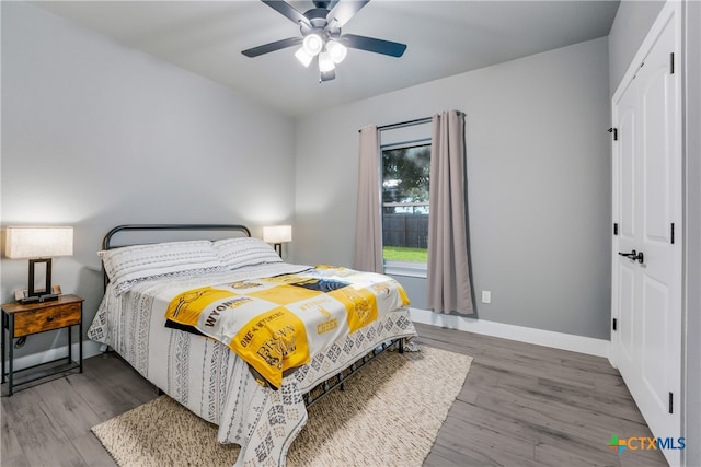 bedroom with ceiling fan and wood-type flooring