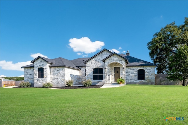 french country style house featuring a front lawn