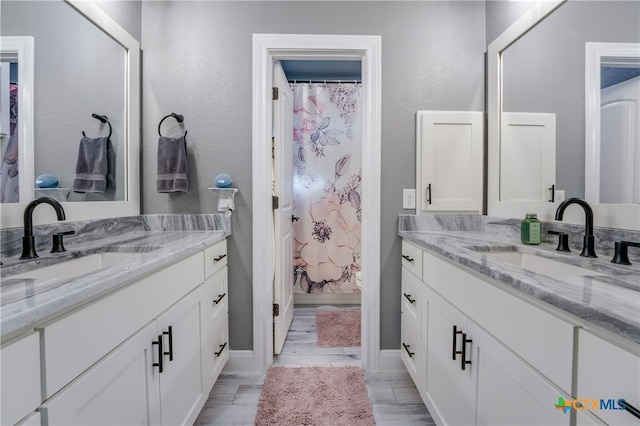 bathroom with vanity, hardwood / wood-style flooring, and a shower with curtain