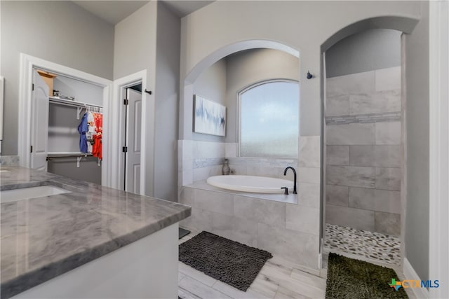 bathroom featuring vanity and plus walk in shower