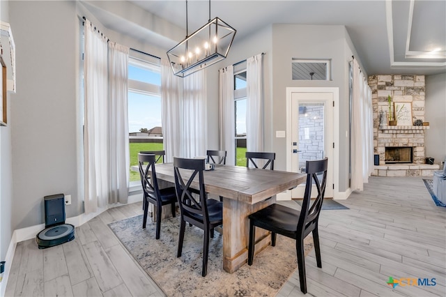 dining room with a fireplace and light hardwood / wood-style flooring