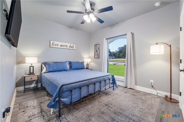 bedroom with hardwood / wood-style flooring and ceiling fan