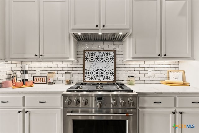 kitchen with white cabinetry, stainless steel range, and decorative backsplash