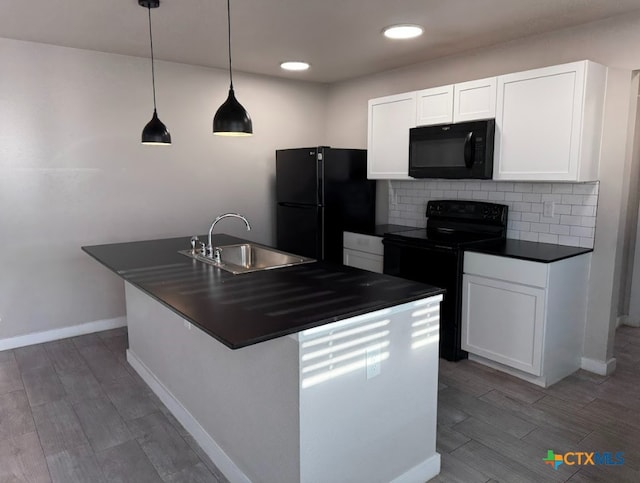 kitchen featuring white cabinets, sink, a center island with sink, and black appliances