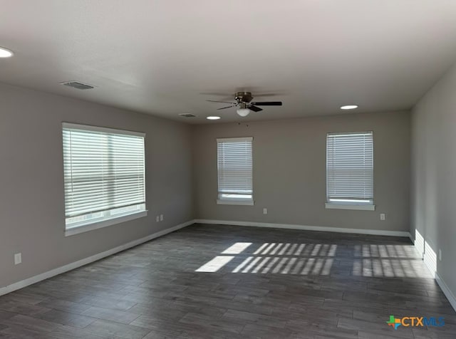 spare room featuring dark hardwood / wood-style flooring and ceiling fan