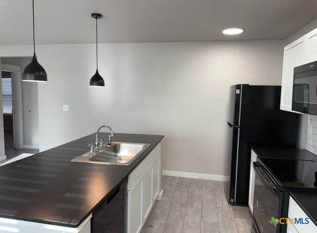 kitchen with sink, white cabinetry, light hardwood / wood-style flooring, pendant lighting, and black appliances