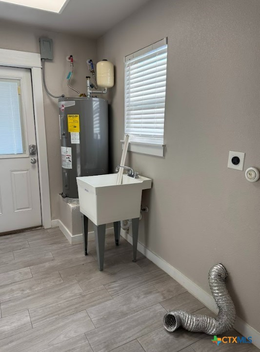 utility room featuring electric water heater