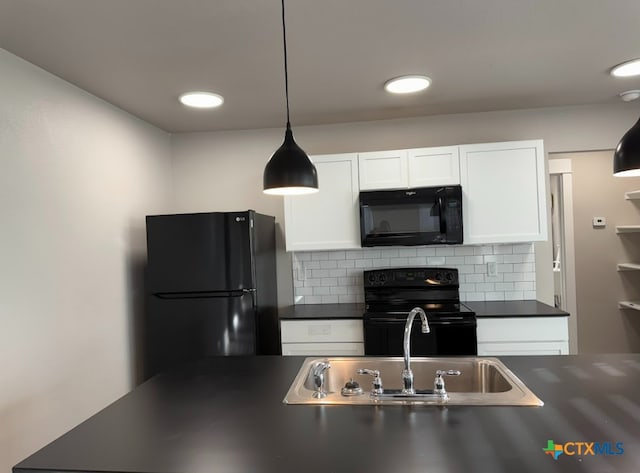 kitchen featuring decorative backsplash, decorative light fixtures, white cabinets, and black appliances