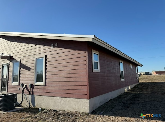 view of side of property featuring central AC unit