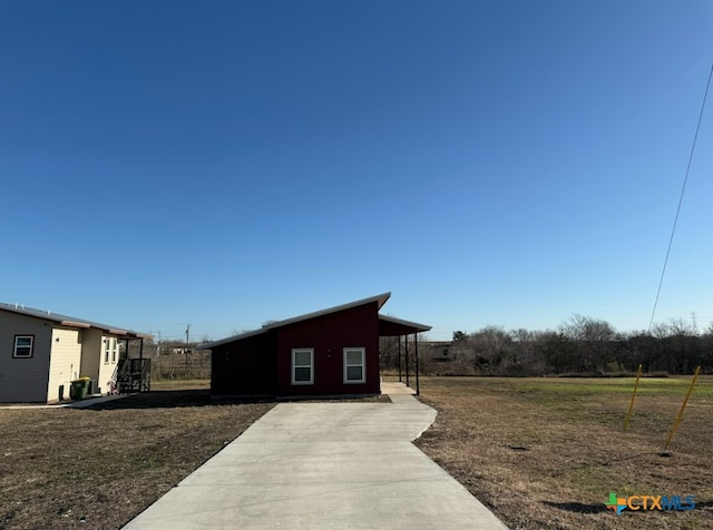 exterior space with a carport and a yard