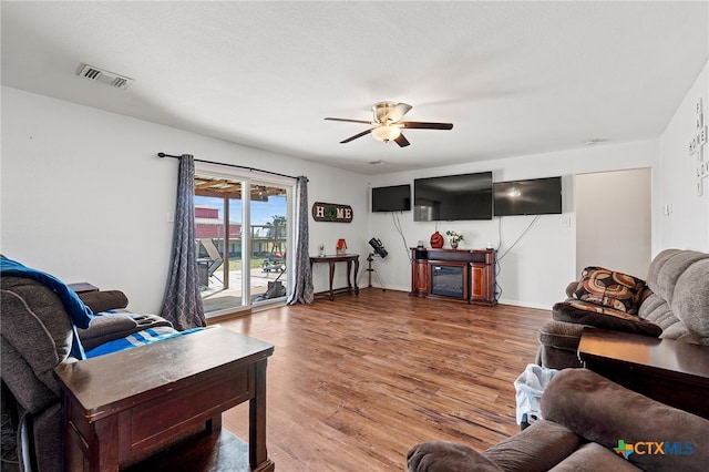 living room with hardwood / wood-style floors and ceiling fan