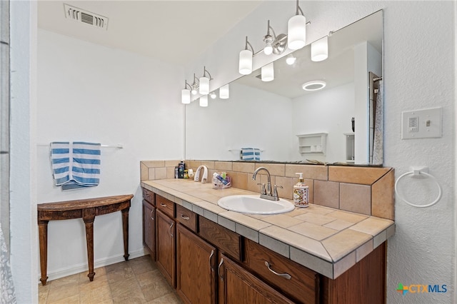 bathroom featuring tasteful backsplash and vanity