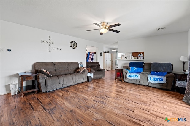 living room featuring hardwood / wood-style flooring and ceiling fan