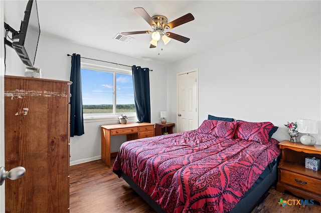 bedroom featuring ceiling fan and dark hardwood / wood-style floors