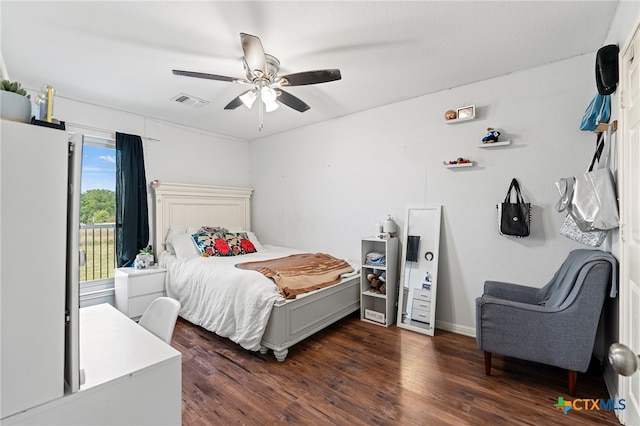 bedroom with dark hardwood / wood-style flooring and ceiling fan